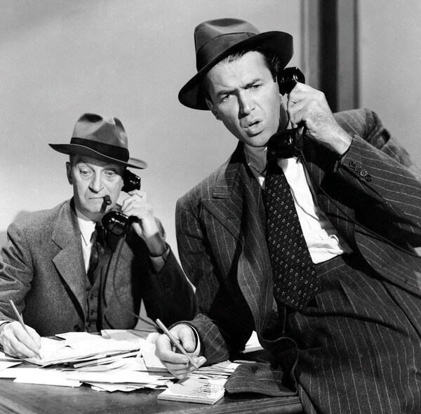 James Stewart and Lee J. Cobb on telephones in a promotional photo for Call Northside 777